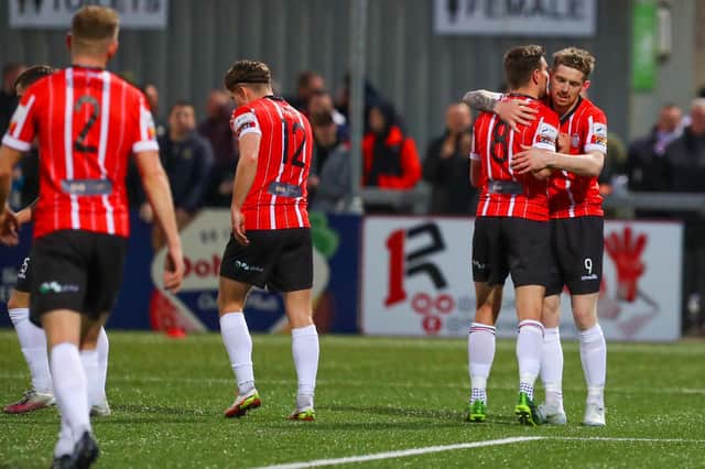 Derry City's Joe Thomson congratulates Jamie McGonigle, after the striker completed his hat-trick. Picture by Kevin Moore/MCI