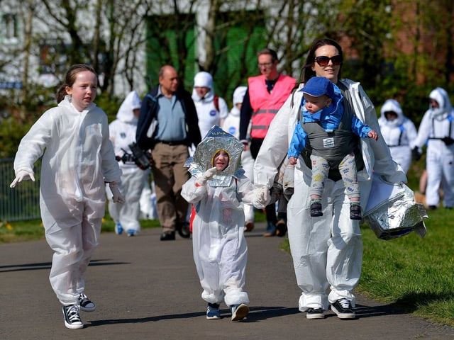 A family arrives at Bay Road Park, on Saturday morning, to take part in a successful world record attempt for the most people dressed as astronauts in one place. Photo: George Sweeney. DER2216GS – 194