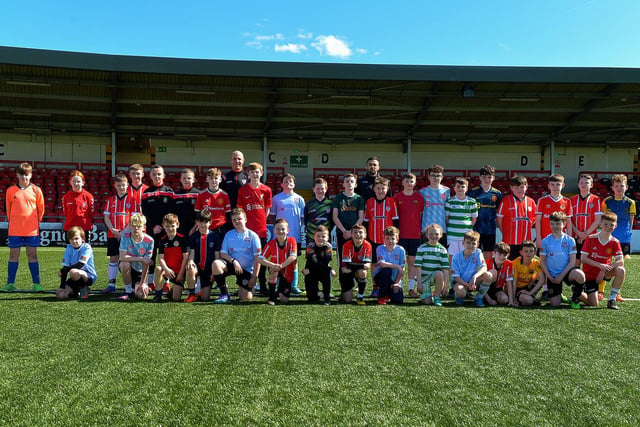 Derry City pair Mark McChrystal and Danny Lafferty pictured with some of the 150 children who attended the Derry City Easter Football Camp at the Brandywell Stadium. Picture: George Sweeney. DER2216GS-073