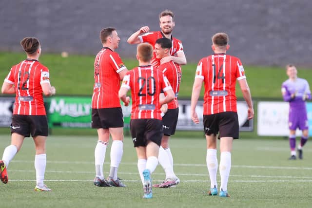 Derry City captain Eoin Toal lifts Cameron Dummigan up after the midfielder scored his first goal for the club, against UCD, on Friday night. Picture by Kevin Moore/MCI