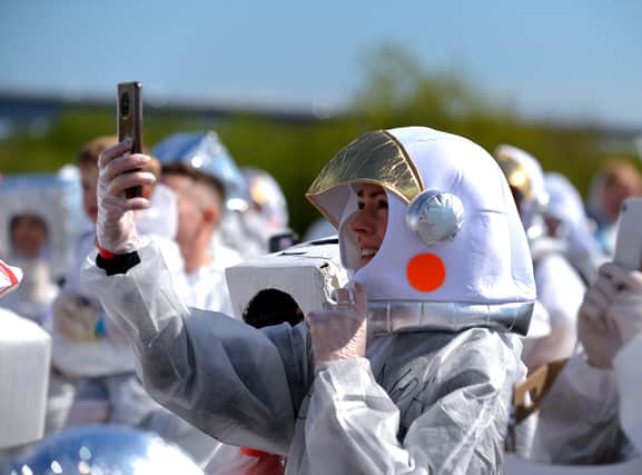 Enjoying the fun and sun in Bay Road Park, on Saturday morning, before the count for the world record attempt for the most people dressed as astronauts in one place. Photo: George Sweeney. DER2216GS – 209