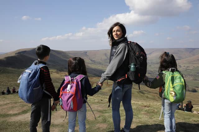 Julia Bradburywith her children walking at Mam Tor in the Peak District