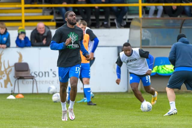 Finn Harps players wore t-shirts to raise awareness of the Lifeline (Inishowen) Domestic Violence Service during their warm-up before the SSE Airtricity Premier Division match between Finn Harps and Derry City on 9th April 2022 in Finn Park, Ballybofey, County Donegal, Ireland. Pictured is Élie-Gaël N’Zeyi Kibonge