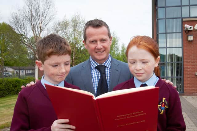 St. Eithne's PS principal Terence McDowell with pupils David Flanagan and Aoife O’Reilly who had stories published in the ‘Creative Writing Project’ book.