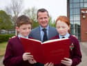 St. Eithne's PS principal Terence McDowell with pupils David Flanagan and Aoife O’Reilly who had stories published in the ‘Creative Writing Project’ book.