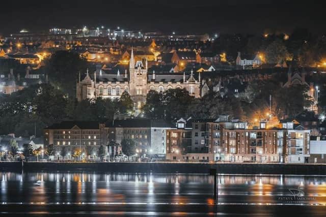 Ulster University's Magee campus dominates the night-time skyline of Derry.