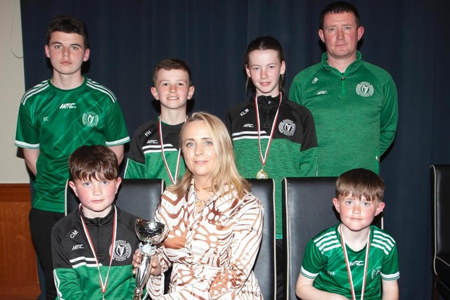 Caroline Casey, O'Neill's Sportswear presenting the U10 Winter Cup to Foyle Harps at Thursday night's D&D awards. At back are coaches Eoghan Campbell and Calvin Mooney. Picture by Jim McCafferty