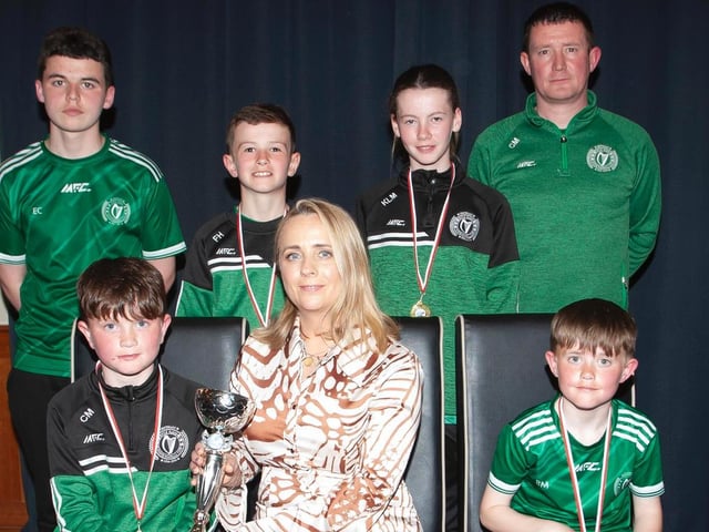 Caroline Casey, O'Neill's Sportswear presenting the U10 Winter Cup to Foyle Harps at Thursday night's D&D awards. At back are coaches Eoghan Campbell and Calvin Mooney. Picture by Jim McCafferty