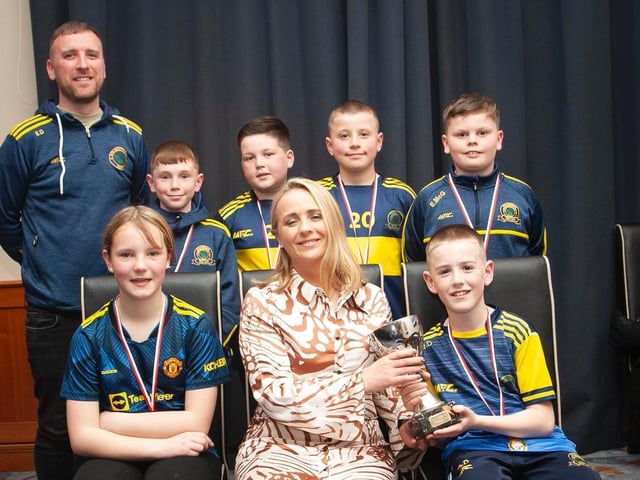 Caroline Casey, O'Neill's Sportswear presenting the U10 Winter Plate to Don Boscos FC at Thursday night's D&D awards. At back is coach Eamon Daly. Picture by Jim McCafferty