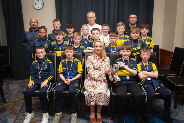 Caroline Casey, O'Neill's Sportswear presenting the U11 Winter Cup to Don Boscos Colts at Thursday night's D&D awards. At back are coaches Dermot Kelly, Sean Starrs and Declan Stokes. Picture by Jim McCafferty