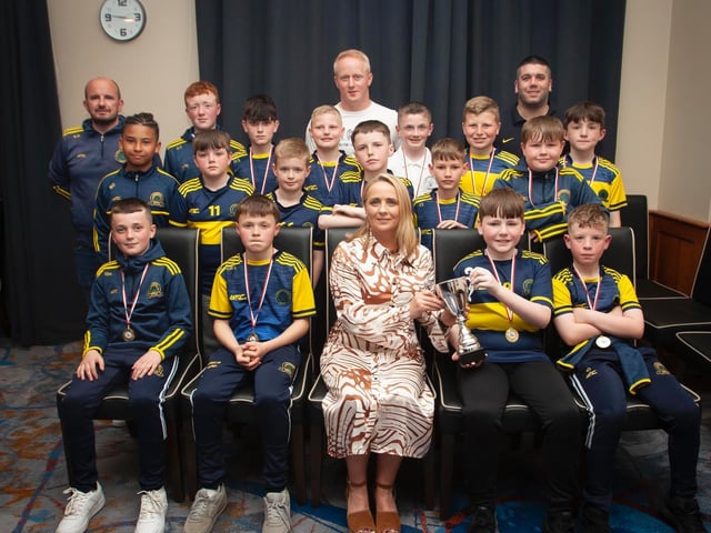 Caroline Casey, O'Neill's Sportswear presenting the U11 Winter Cup to Don Boscos Colts at Thursday night's D&D awards. At back are coaches Dermot Kelly, Sean Starrs and Declan Stokes. Picture by Jim McCafferty