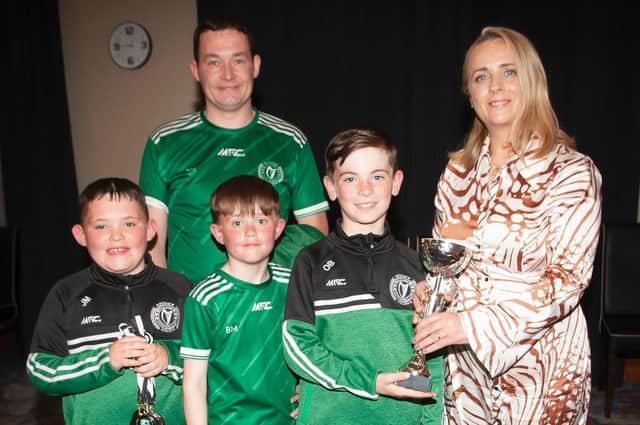 Caroline Casey, O'Neill's Sportswear presenting the U10 Cup to Foyle Harps at Thursday night's D&D awards. At back is coach Ronan Mooney. Picture by Jim McCafferty