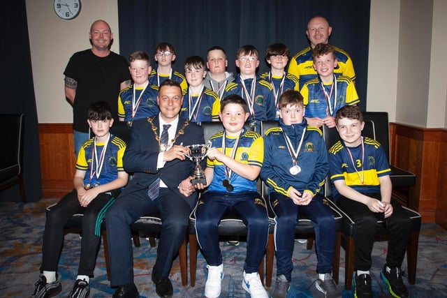 The Mayor, Graham Warke presenting Don Boscos FC U11s with the Winter Cup at Thursday night's awards. They also were runners-up in the Premiership. At back are coaches Terence Bradley and Gerry McGinley. Picture by Jim McCafferty