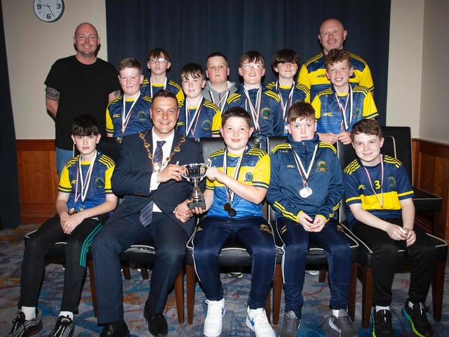 The Mayor, Graham Warke presenting Don Boscos FC U11s with the Winter Cup at Thursday night's awards. They also were runners-up in the Premiership. At back are coaches Terence Bradley and Gerry McGinley. Picture by Jim McCafferty