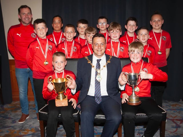 The Mayor, Graham Warke presents the U12 League Championship trophy to Newell Academy on Thursday night. At back is coach Sandy Gillespie. Picture by Jim McCafferty