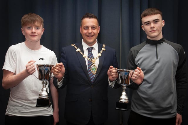 The Mayor, Graham Warke presenting Trojans FC players Calum Deery and Emmett McBrearty with the U14 League and Cup trophies on Thursday night. Picture by Jim McCafferty