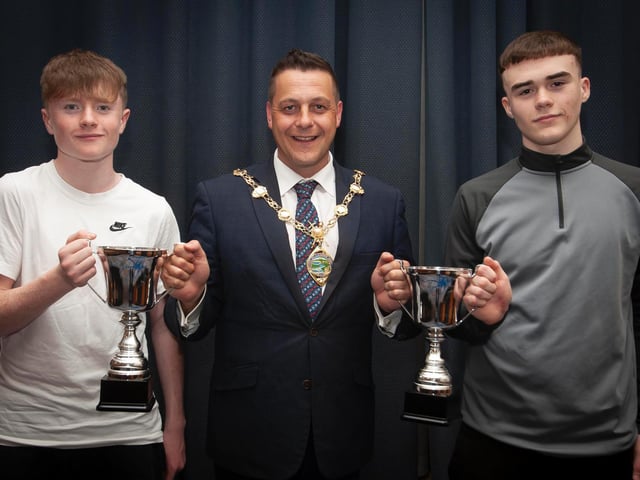 The Mayor, Graham Warke presenting Trojans FC players Calum Deery and Emmett McBrearty with the U14 League and Cup trophies on Thursday night. Picture by Jim McCafferty