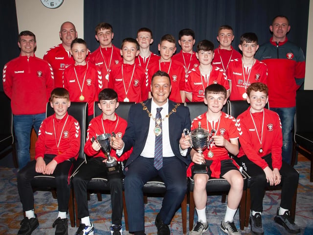 The Mayor, Graham Warke presenting Tristar U12s with the league trophy and Summer Cup at Thursday night's awards. At back are coaches Vinnie Morrison, Sean Curran and Jim Kearney. Picture by Jim McCafferty