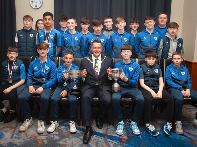 The Mayor, Graham Warke presenting Oxford United Stars FC U14s with the League Cup at Thursday night's awards. At back are coaches Jodie Walker and John Walker. Picture by Jim McCafferty