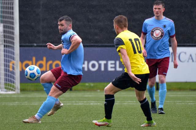 Institute captain Cormac Burke passes the ball before Knockbreda’s Stephen Garrett could challenge. Picture by George Sweeney.