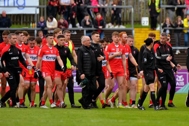 Derry manager Rory Gallagher chats with a match official as he leads his players off the pitch at half-time in Healy Park on Sunday afternoon last.  Photo: George Sweeney.  DER2218GS – 004