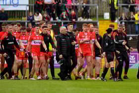 Derry manager Rory Gallagher chats with a match official as he leads his players off the pitch at half-time in Healy Park on Sunday afternoon last.  Photo: George Sweeney.  DER2218GS – 004
