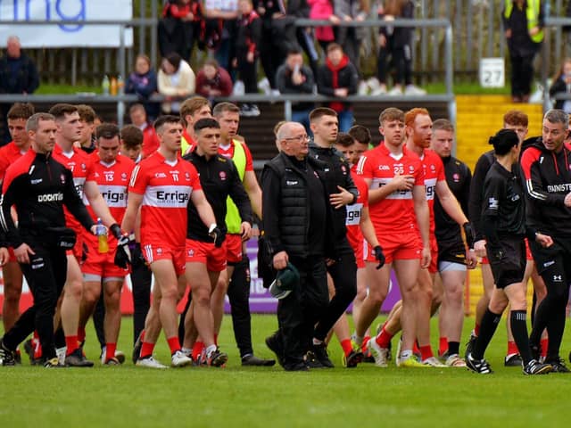 Derry manager Rory Gallagher chats with a match official as he leads his players off the pitch at half-time in Healy Park on Sunday afternoon last.  Photo: George Sweeney.  DER2218GS – 004