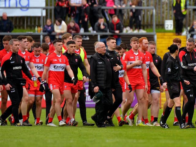 Derry manager Rory Gallagher chats with a match official as he leads his players off the pitch at half-time in Healy Park on Sunday afternoon last.  Photo: George Sweeney.  DER2218GS – 004
