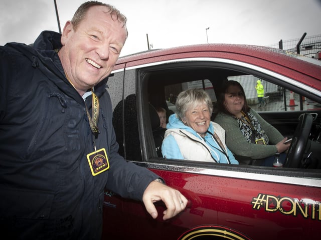 Car enthusiast and Bear Run 74 participant Joe Jackson pictured with the Mayorâ€TMs mother, Jeanette Warke in one of his cars on Saturday morning at City of Derry Airport.