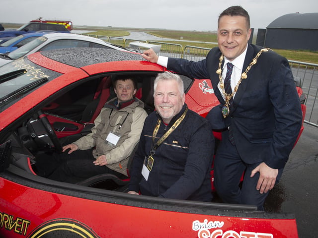 Benjamin Thompson gets to try out Des Adamâ€TMs C8 Corvette at Saturayâ€TMs VIP event. On right is Mayor, Graham Warke.