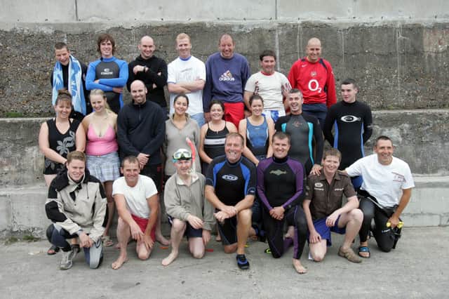 Participants in the annual charity swim from Saddle Rock to Portmore Pier in aid of the Donegal Hospice and Foyle Hospice. Front, from left, are Conal Morrison, Martin O'Connor, Fr. Peter Deeney, Aidan McKinney, Mark Mullarkey, Colm Kelly and Frank Dunlop. Centre, from left, are Colette Doherty, Ann Marie Coffey, Daniel Conaghan, Sandra McKeeney, Catherine Kelly, Julie Doherty, Hugh McDonald and Ronan Doherty. Back, from left, are Anthony Coffey, Emmet Gibson, Emmet Farren, Aidan Doherty, Paul Doherty, Gerard Stevens and Kevin Farren. (1808C01)