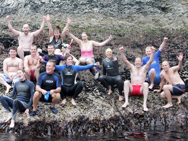 Swimmers on Saddle Rock before setting off on the charity swim to shore. (1808C02)