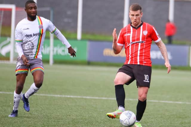 Patrick McEleney on the ball for Derry City against Bohemians as ex-City striker Junior Ogedi-Uzokwe closes in.