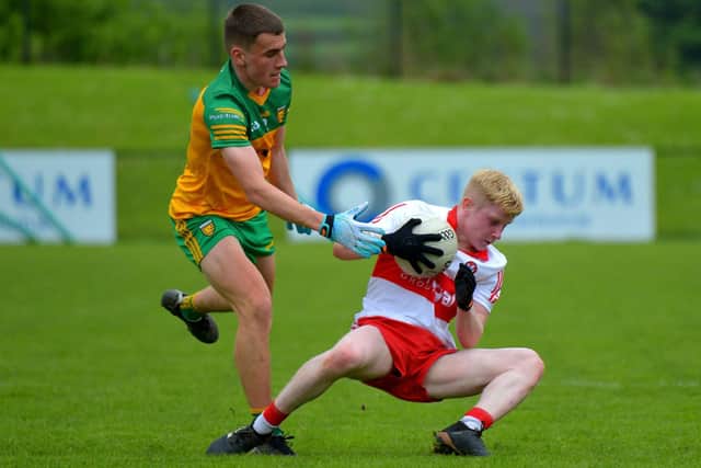 Derry’s Fionn McEldowney evades a challenge from Donegal’s Karl Joseph Molly during the Ulster Minor Championship game at Owenbeg on afternoon last. Photo: George Sweeney. DER2218GS – 021