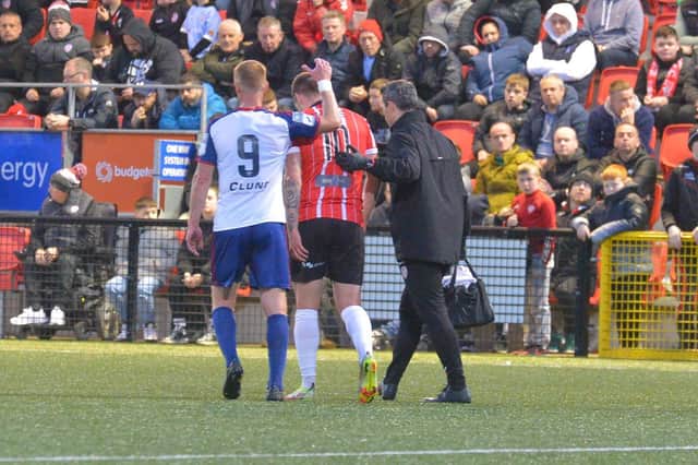 Patrick McEleney makes his way off the pitch at Brandywell after sustaining a hamstring injury as St Pat's striker Eoin Doyle consoles him. Photo by George Sweeney.