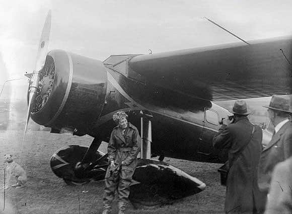 May 1932... Amelia Earhart rests on her plane after it landed on the outskirts of Derry.