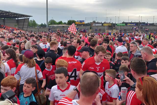 Brendan Rogers and the other Derry players are swamped by fans after Sunday's four point victory over Monaghan in the Athletic Grounds.