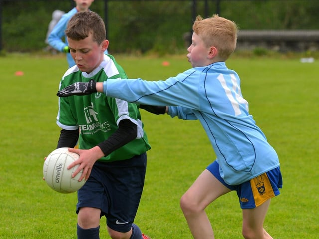 Bunscoil Cholmcille in action against Hollybush ‘B’ in the Steelstown Schools Cup, at Páirc Brid.