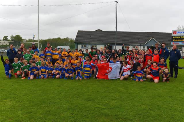 The schools who took part in the recent Steelstown Primary Schools Cup, at Páirc Brid, pictured with a Derry GAA flag.