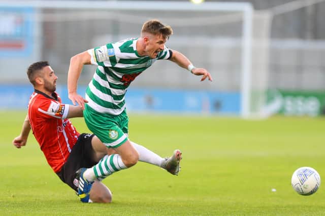 Derry City defender Danny Lafferty slides in to win possession from Shamrock Rovers captain Ronan Finn. Picture by Kevin Moore/MCI