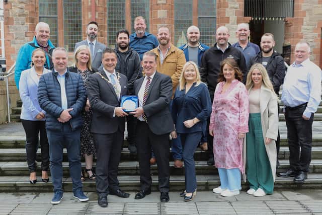 Mayor Graham Warke makes a presentation to Martin Mullan in recognition of his contribution to charity in the City and District at a reception for the Grove Theatre Group. Included are members of the Grove Theatre Group.  (Photo - Tom Heaney, nwpresspics)