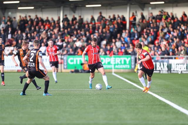 Derry City's Will Patching prepares to set Matty Smith free down the line during the top of the table clash with Dundalk at Brandywell. Photo by Kevin Moore.