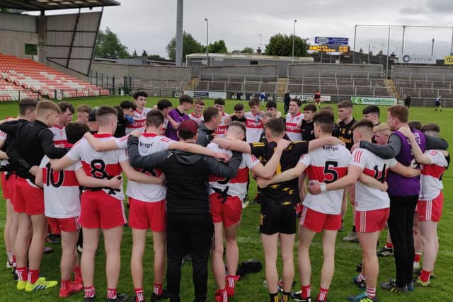 Manager Martin Boyle chats to his Derry minors players after defeating Cavan on Saturday in the Armagh Atheltic Grounds.