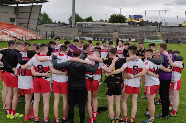 Manager Martin Boyle chats to his Derry minors players after defeating Cavan on Saturday in the Armagh Atheltic Grounds.