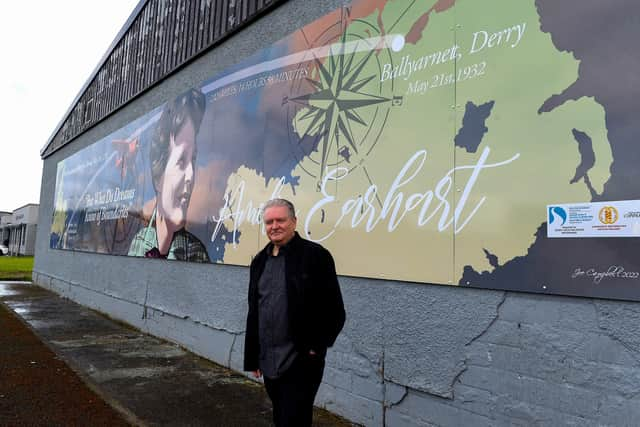 Pictured at the unveiling of a mural commemorating the 90th Anniversary of the landing of Amelia Earhart in Derry on the gable wall of the Galliagh Co-Op on Friday afternoon last is creater of the artwork Derry artist Joseph Campbell.  The digital print created from Joseph’s original artwork spans 48ft wide and 8ft high.  Photo: George Sweeney.  DER2220GS – 066