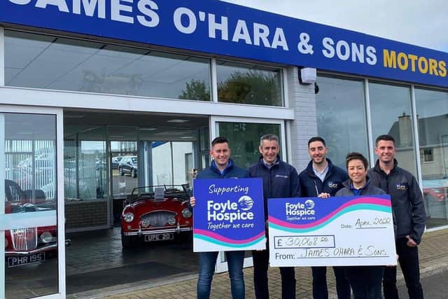 Staff from James O'Hara & Sons Motors with their cheque for the Hosp[ice.