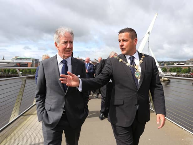 Congressman Richard Neal walks across Derry's Peace Bridge with Mayor Graham Warke on Wednesday. Photo: Lorcan Doherty