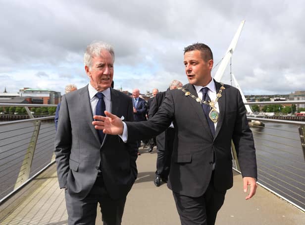 Congressman Richard Neal walks across Derry's Peace Bridge with Mayor Graham Warke on Wednesday. Photo: Lorcan Doherty