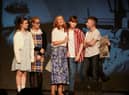 Actors on stage in 'A Green Hill Far Away'.