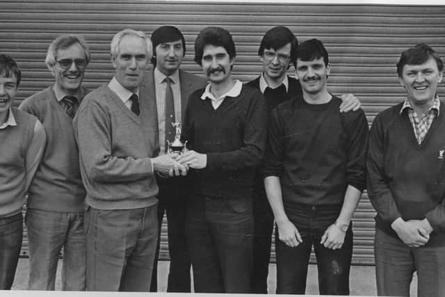 Eamonn Davis receives first prize in one of the Journal's golf society outings in the 1980s. Pictured receicing the trophy from society capatian Gerry Gallagher. Also pictured, from left, Dessie McCallion, the late Joe Martin, John McManus, Cecil McGill, Arty Duffy and Newell McBride.